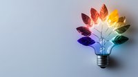 Colorful leaves growing from light bulb on gray background, symbolizing creative ideas, innovation, and environmental sustainability.