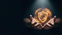 Hands holding glowing golden spiral energy orb against dark background, representing power, magic, innovation, technology, and spiritual transformation for business and design projects.