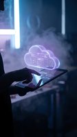 Businessman using tablet with glowing cloud computing hologram displaying data analytics dashboard in modern office environment for digital transformation.