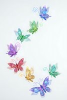 Colorful watercolor butterflies with decorative swirls on white background, isolated design elements for spring greeting cards and nature projects.