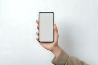 Hand holding modern smartphone with blank white screen mockup against neutral background for app presentation and digital marketing materials.