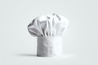 White professional chef hat or toque blanche isolated on light background, traditional culinary uniform element with pleated design and crisp texture.