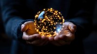 Glowing sphere with golden light particles network floating between hands against dark background, representing global connectivity and digital transformation.