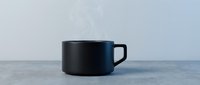 Black ceramic coffee cup on marble surface with minimalist modern design for kitchen and dining concepts.