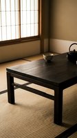Minimalist zen interior with black wooden table, ceramic bowl, and traditional teapot on tatami mat flooring, illuminated by soft natural light from shoji window screens.
