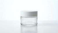 Empty clear glass cosmetic jar with white lid, isolated on white background, ready for branding, packaging design, and beauty product mockups.