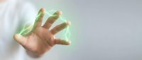 Hand with glowing green energy aura emerging from fingers, isolated on white background, suitable for technology, power, and digital design projects.