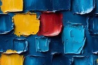 Abstract textured background with thick paint strokes in vibrant blue, yellow and red colors creating dimensional squares pattern. Modern artistic composition.