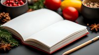 Open blank recipe book with pencil surrounded by fresh vegetables, spices and ingredients on dark background. Perfect for cooking blog or food content.