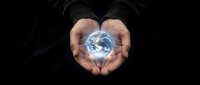 Hands holding glowing Earth globe against dark background, symbolizing environmental protection, sustainability, and global responsibility for business and conservation campaigns.