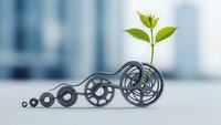 Green plant seedling growing from mechanical gears symbolizing sustainable business growth and eco-friendly innovation in modern office environment.
