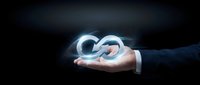 Businessman hand holding glowing infinity symbol representing endless possibilities, growth, and sustainable business solutions for corporate presentations.
