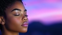 Young African American woman with natural curly hair in peaceful meditation pose against purple sunset sky background, eyes closed, serene expression.