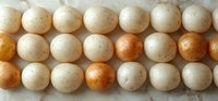 Fresh white and brown chicken eggs arranged in neat rows on light background, showing natural variation in color and texture of farm-fresh eggs.
