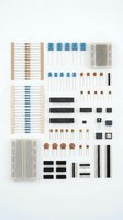 Electronic components kit with resistors, capacitors, breadboards and connectors organized on white background for DIY projects and prototyping.