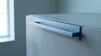 Modern kitchen cabinet with sleek chrome handle in contemporary interior design for home renovation and furniture projects.