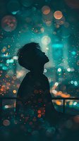 Silhouette of person gazing upward against turquoise night sky with glowing orange bokeh lights creating magical dreamy atmosphere. Artistic urban photography.