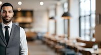 Confident male professional in formal business attire standing in modern office environment with blurred conference room background, suitable for corporate, leadership and workplace concepts.