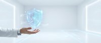 Businessman hand presenting holographic cybersecurity shield icon in modern digital workspace for data protection and network security solutions.