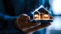 Glowing hologram house floating above smartphone in dark room with magical sparkles and blue light, concept of smart home technology and digital real estate.