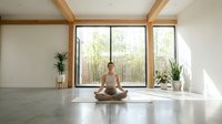 Young woman practicing meditation in modern minimalist room with large windows overlooking bamboo garden, peaceful yoga studio interior design.