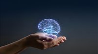 Hands holding glowing brain hologram against dark background, representing artificial intelligence, neuroscience, innovation, and digital technology concepts for business and science.