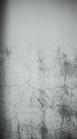 Weathered cracked concrete wall texture with peeling paint and grunge stains for vintage industrial backgrounds and distressed design projects.