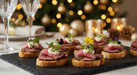 Gourmet beef tartare canapes with microgreens on slate board for elegant holiday party appetizers and festive dining celebration.