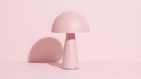 Minimalist table lamp with dome shade in soft pink tones, isolated on matching background, suitable for interior design, home decor, and modern furniture concepts.