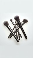 Professional makeup brush set with soft gray bristles and sleek black handles, arranged on a white background for beauty and cosmetics concepts.
