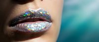 Close-up of lips with holographic glitter makeup, featuring iridescent sparkle effect and metallic shimmer. Suitable for beauty, cosmetics, makeup tutorials, and fashion editorial use.