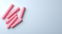 Pink chalk sticks arranged on white background for educational and creative projects, isolated design element for school supplies and art materials.