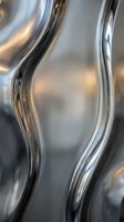 Abstract metallic curves with reflective chrome surface creating flowing liquid metal waves for modern design backgrounds.