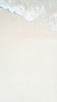Aerial view of gentle ocean waves washing onto pristine sandy beach, creating soft foam patterns. Ideal for travel, vacation, and coastal design projects.