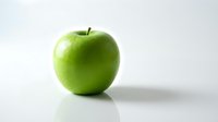 Fresh green apple isolated on white background, suitable for healthy eating, nutrition, and food packaging design projects.