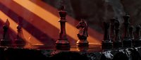 Strategic chess game with wooden pieces on board featuring dramatic sunset lighting and atmospheric smoke effects for competitive gaming concepts.