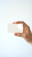 Hand holding blank white business card mockup on clean background for branding and corporate identity design projects.