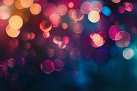 Colorful bokeh lights creating magical atmosphere with pink, orange and blue blurred circles on dark background, abstract festive backdrop for celebrations.