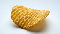 Golden crispy ridged potato chip with textured surface isolated on white background for snack food packaging and culinary design projects.