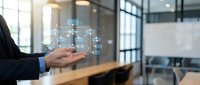 Businessman holding digital network diagram in modern office conference room showcasing connectivity and technology solutions for corporate presentations.