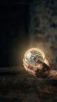 Male hands holding glowing crystal ball containing circuit board and digital network connections, symbolizing technology innovation, future vision, and digital transformation for business concepts.