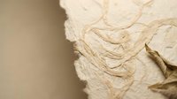 Handmade paper with natural fibers and organic texture for craft projects and artistic backgrounds.