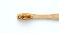 Natural bamboo toothbrush with eco-friendly bristles isolated on white background for sustainable oral care and zero waste lifestyle products.