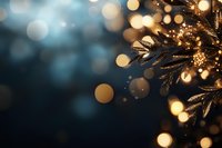 Magical golden bokeh lights with pine branches in dark blue background create dreamy festive atmosphere for winter holiday designs and cards.