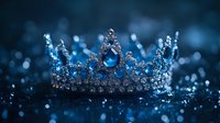 Sparkling silver crown with blue gemstones on dark background with bokeh lights, royal symbol of power and luxury for fantasy and fairy tale designs.
