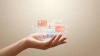 Caucasian hand holding glowing digital business analytics icons and data visualization elements representing financial growth and technology solutions.