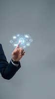 Businessman hand touching digital communication icons on gray background for customer service and business technology concepts.