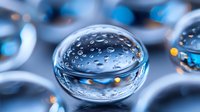 Water drops on blue surface with bokeh effect creating spherical macro photography with light refraction and transparent liquid patterns for abstract backgrounds.