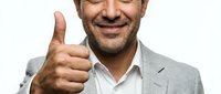 Middle-aged Caucasian male professional wearing light gray blazer and white shirt, smiling with thumbs up gesture against white background, isolated for business and corporate design use.