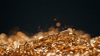 Golden metal chain links on dark background with soft bokeh lights and shallow depth of field, luxury jewelry macro photography.